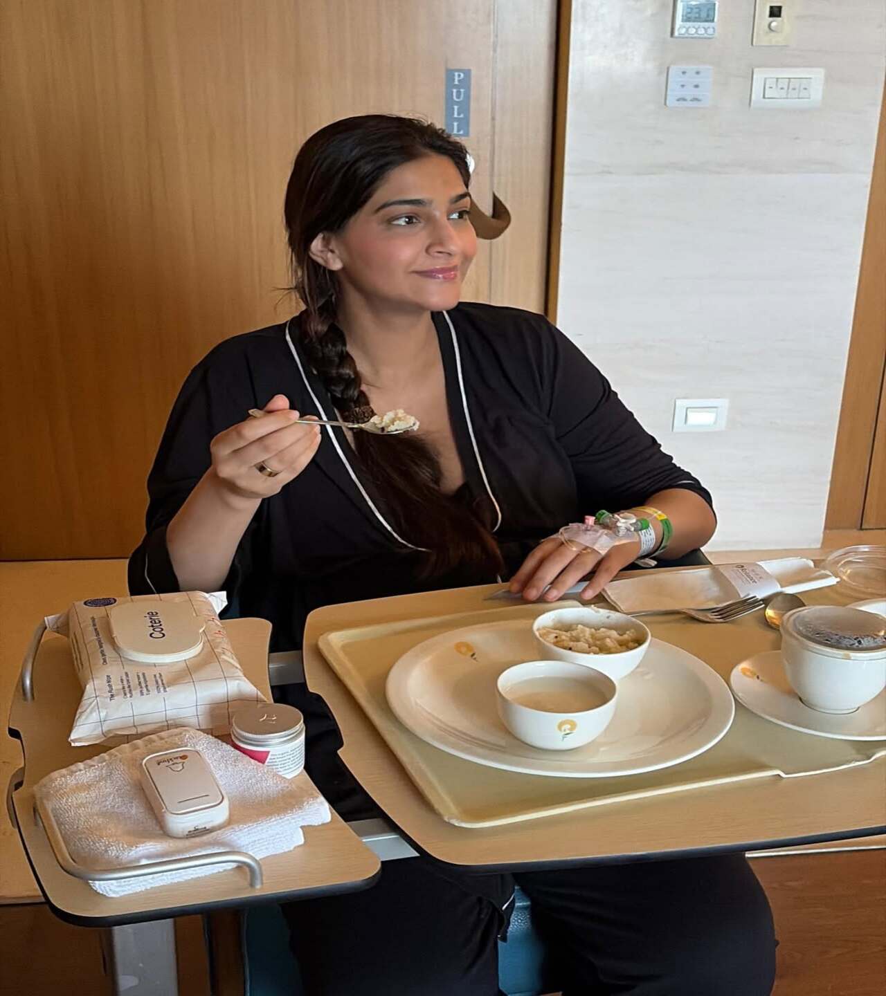 In the second photo she shared, Sonam is seated beside a hospital tray, dressed in comfortable black loungewear. She is seen having a meal, and the picture appears to be a candid click
